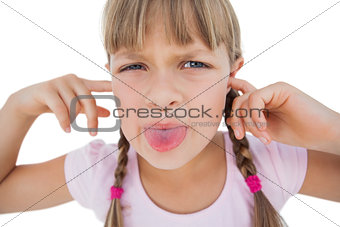 Little girl clogging her ears and wincing