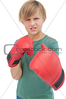 Furious blonde boy with boxing gloves