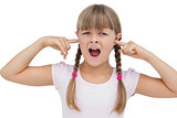 Little girl clogging her ears with her fingers