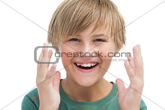 Suprised blonde boy with hands up smiling