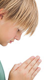 Little boy praying with eyes closed