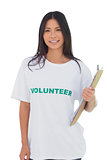 Woman wearing volunteer tshirt holding clipboard