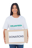 Smiling volunteer holding a donation box