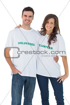 Two cheerful people wearing volunteer tshirt