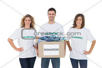 Smiling group of volunteers holding donation box