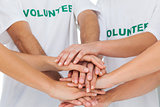 Volunteers piling up their hands together