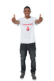 Handosme man wearing blood donor giving thumbs up