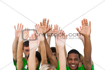 Smiling group of people raising arms
