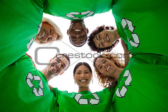 Low angle view of people wearing green shirt with recycling symbol on it