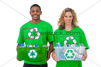 Two  cheerful environmental activists holding box of recyclables