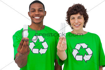 Two environmental activists holding light bulbs