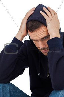 Portrait of depressed man with head in hands
