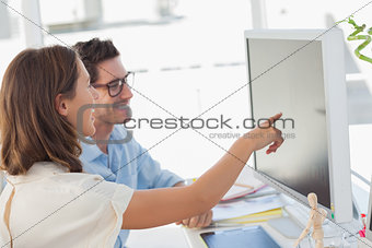 Attractive photo editor pointing at the screen