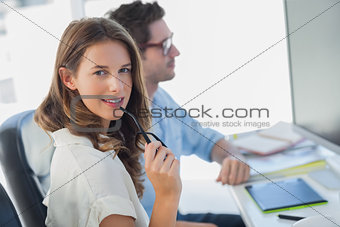 Attractive photo editor biting her reading glasses