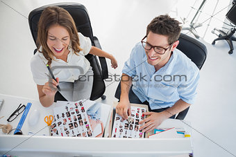Cheerful photo editors working on a computer