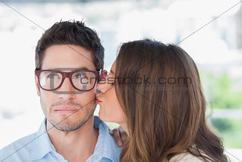 Attractive designer giving a kiss to a colleague