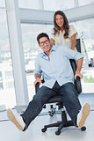 Happy designers having fun with a swivel chair