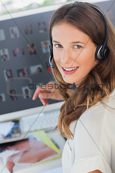 Portrait of a cheerful photo editor wearing a headset