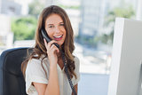 Cheerful businesswoman having a phone conversation