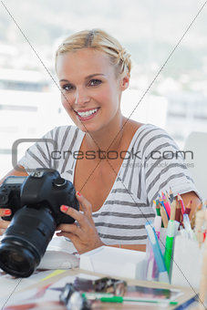 Photo editor looking at her digital camera