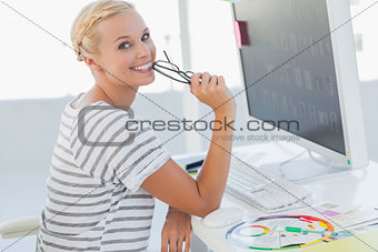 Attractive photo editor at her desk