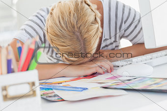 Overworked designer napping on her desk