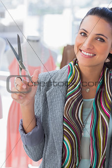 Pretty designer holding scissors