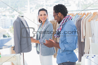 Fashion designers adjusting blazer
