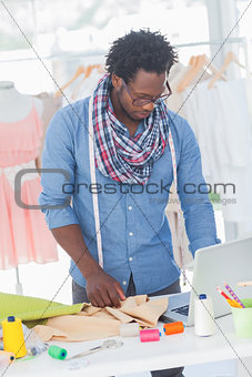 Fashion designer working on his laptop