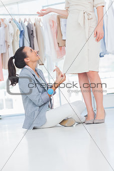 Fashion designer talking to model