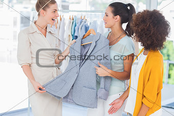 Smiling women holding a blazer