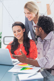 Team of designers working on laptop