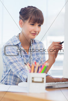 Happy designer working on her computer