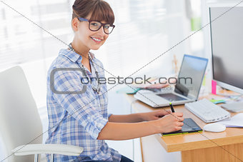 Pretty designer working on her graphics tablet