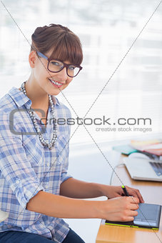 Pretty designer working on graphics tablet
