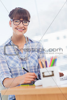 Cheerful designer working on graphics tablet