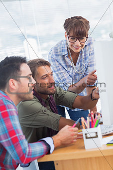 Group of designers working on a computer