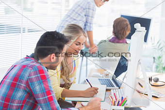 Cheerful designers working on a document