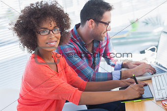 Graphic designer using a graphics tablet in her office