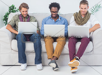 Handsome designers working with laptops