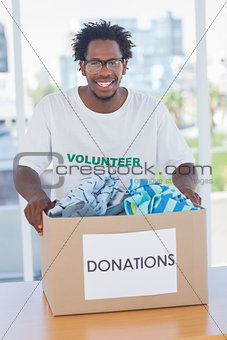 Happy man holding donation box