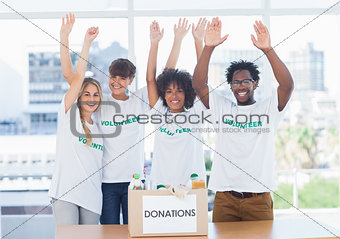 Volunteers raising their arms