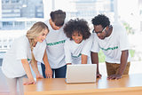 Volunteers working together on a laptop