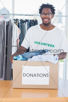 Handsome man holding a donation box