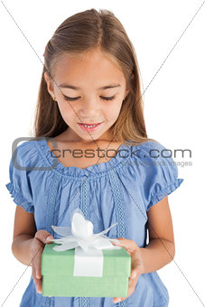 Cute little girl holding a wrapped gift