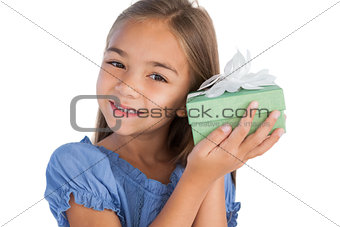 Smiling girl excited while holding a present