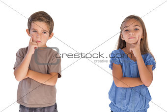 Thoughtful children standing with arms crossed