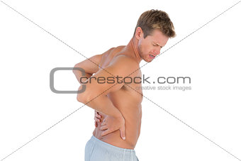 Topless man suffering from back pain