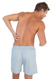 Man with shorts suffering from lower back pain