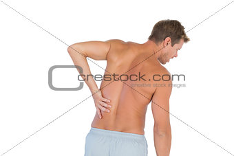 Man rubbing his back because of a back pain